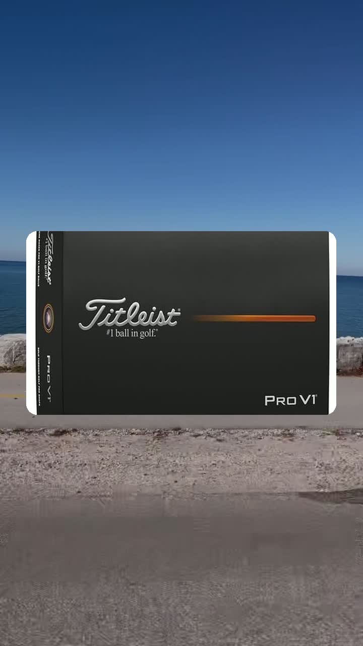 Titleist Pro V1 dozen box standing by the lake under a clear blue sky
